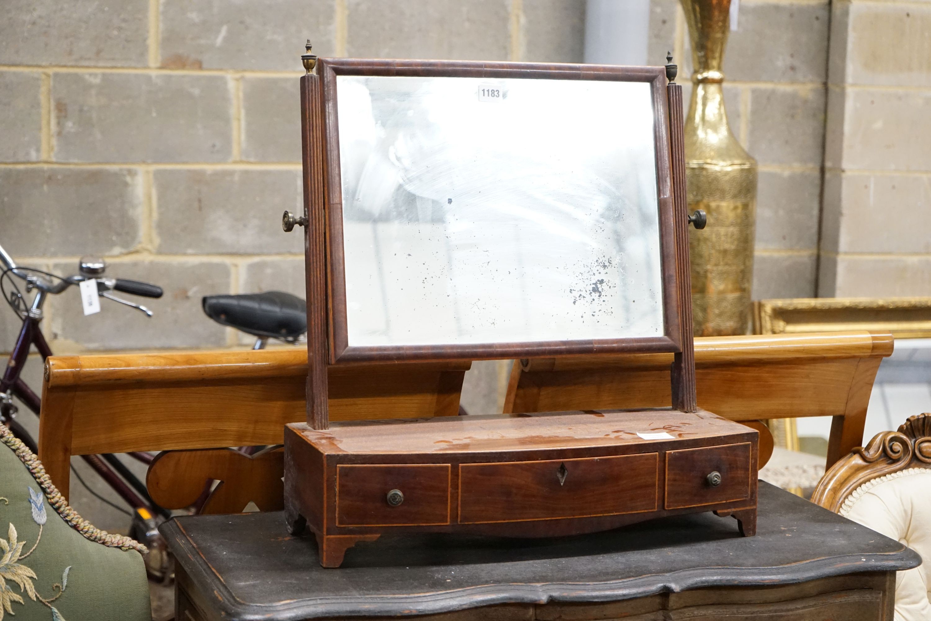 A George IV inlaid mahogany bow fronted box base toilet mirror, width 57cm, depth 22cm, height 62cm